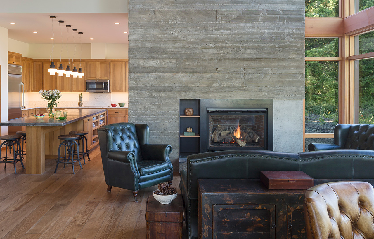 Open concept kitchen and fireplace of Suncadia Resort net zero home by Seattle sustainable architecture company